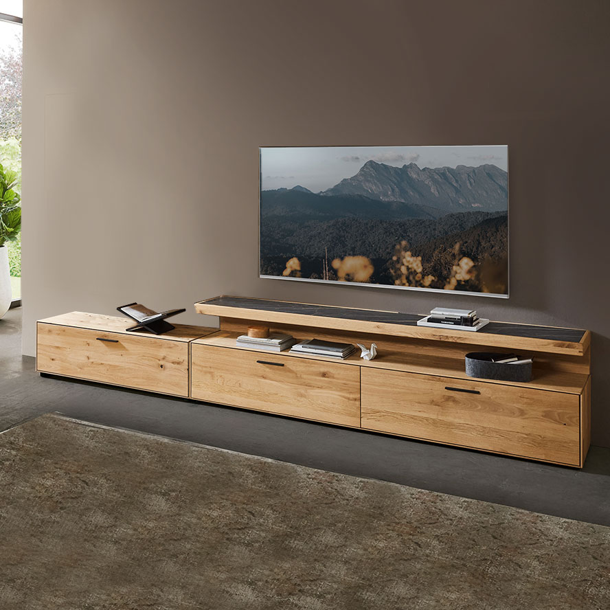 Kachel Lowboard WM 2520 Hier werden Sie zu den Lowboard der Serie WM 2520 weitergeleitet:  Kachel zeigt Lowboard in hochwertiger Wildeiche, in Kombination mit echt Steinfunier Akzent.